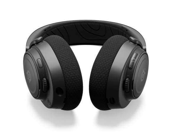 
 An Arctis Nova headset laying on a surface with the controls visible.
 